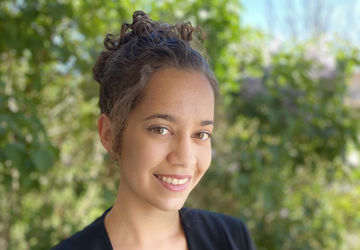 Photo of Monica Kneusel in front of trees