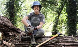 Brenna sitting on a rock