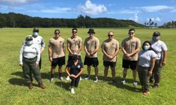 Masked group of volunteers standing in a field