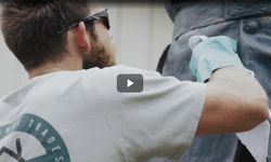 Rodney works on a project back facing camera